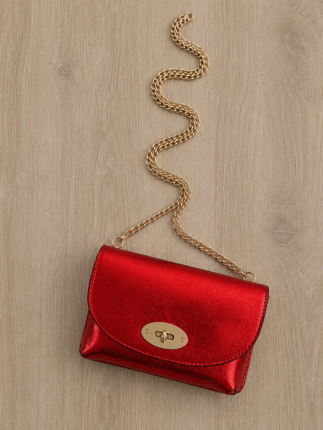 Sac bandoulière en cuir métallisé pour femme avec chaîne dorée, modèle Positano 18 × 11 cm, disponible en plusieurs coloris.