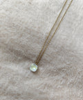 Collier Nerja en acier inoxydable doré avec pendentif en pierre facettée colorée blanc disponible en plusieurs coloris.