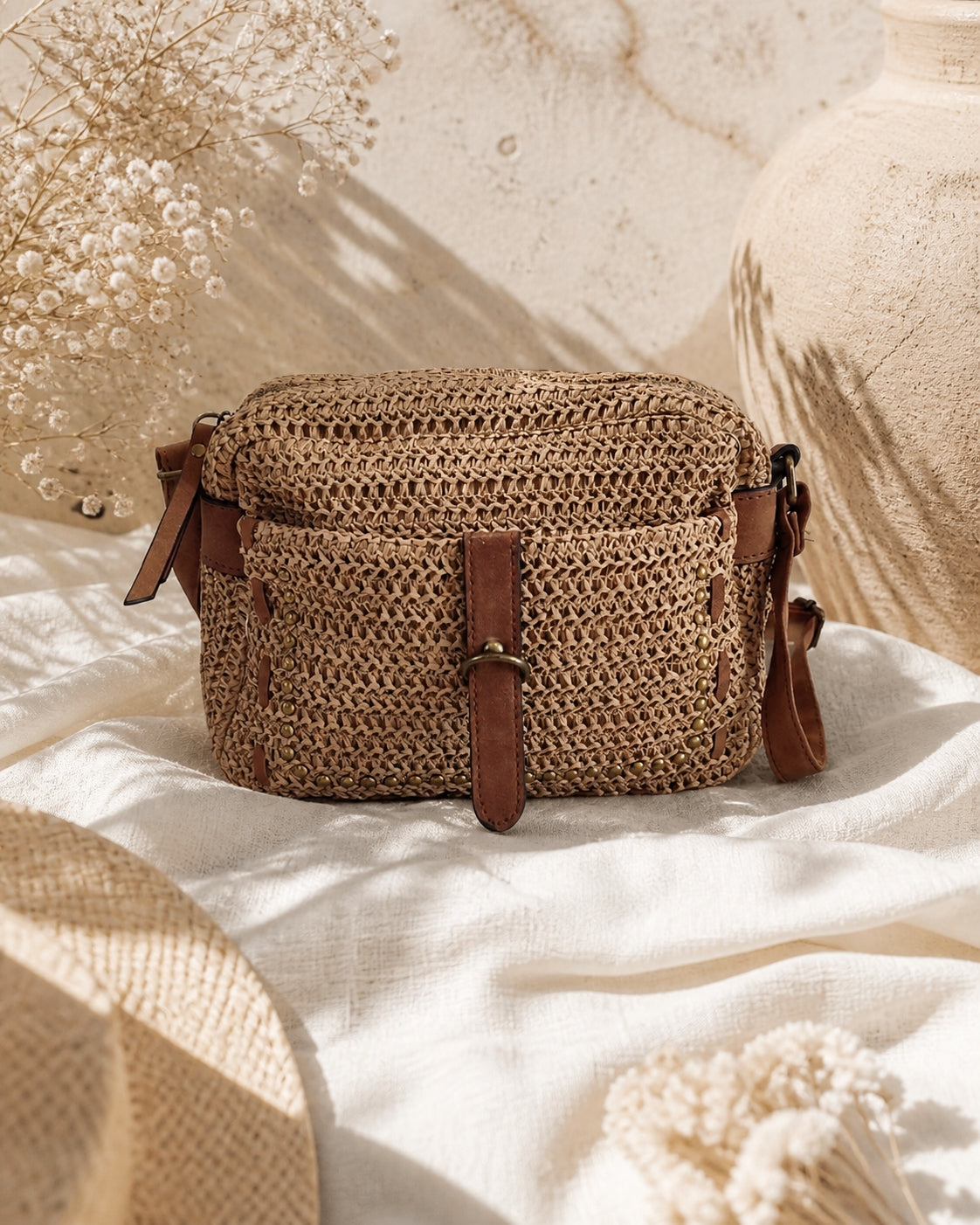 Sac bandoulière Calvi en raphia écru avec détails marron et clous décoratifs